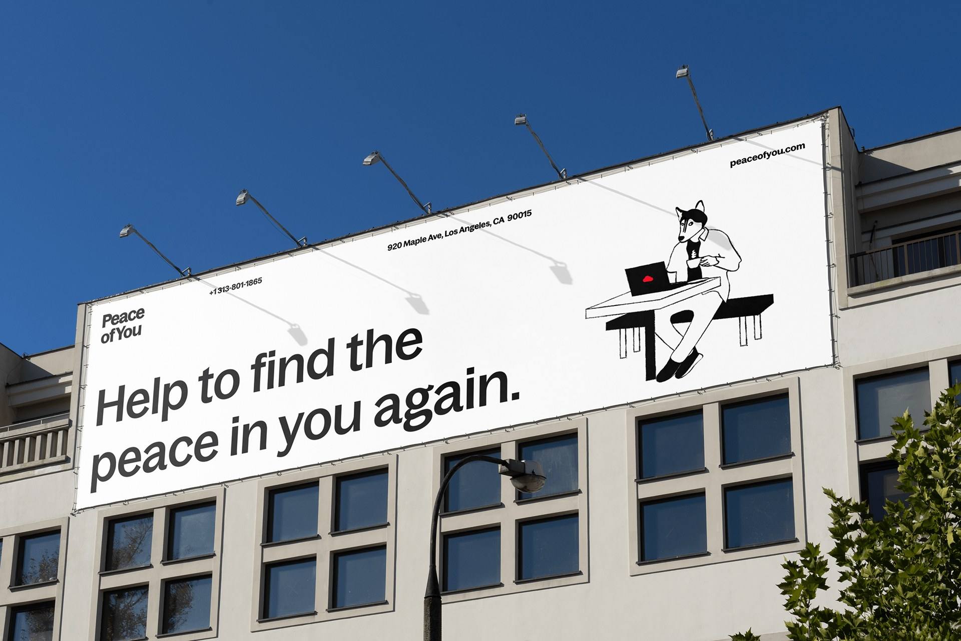 Білборд Peace of You на фасаді: «Help to find the peace in you again.» і персонаж за ноутбуком